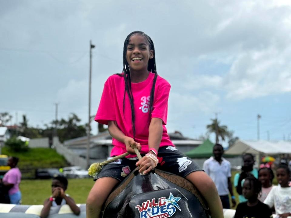 Girl laughing on the WildRides mechanical bull